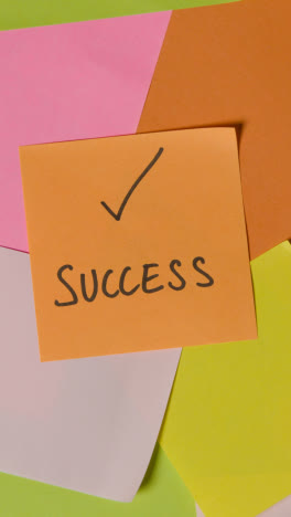 Vertical-Video-Business-Concept-Of-Revolving-Sticky-Notes-With-Success-Written-On-Top-Note-1